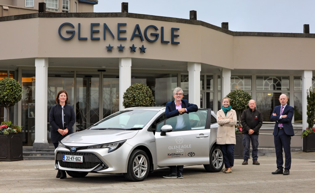 The car in front (of the hotel) is a Toyot